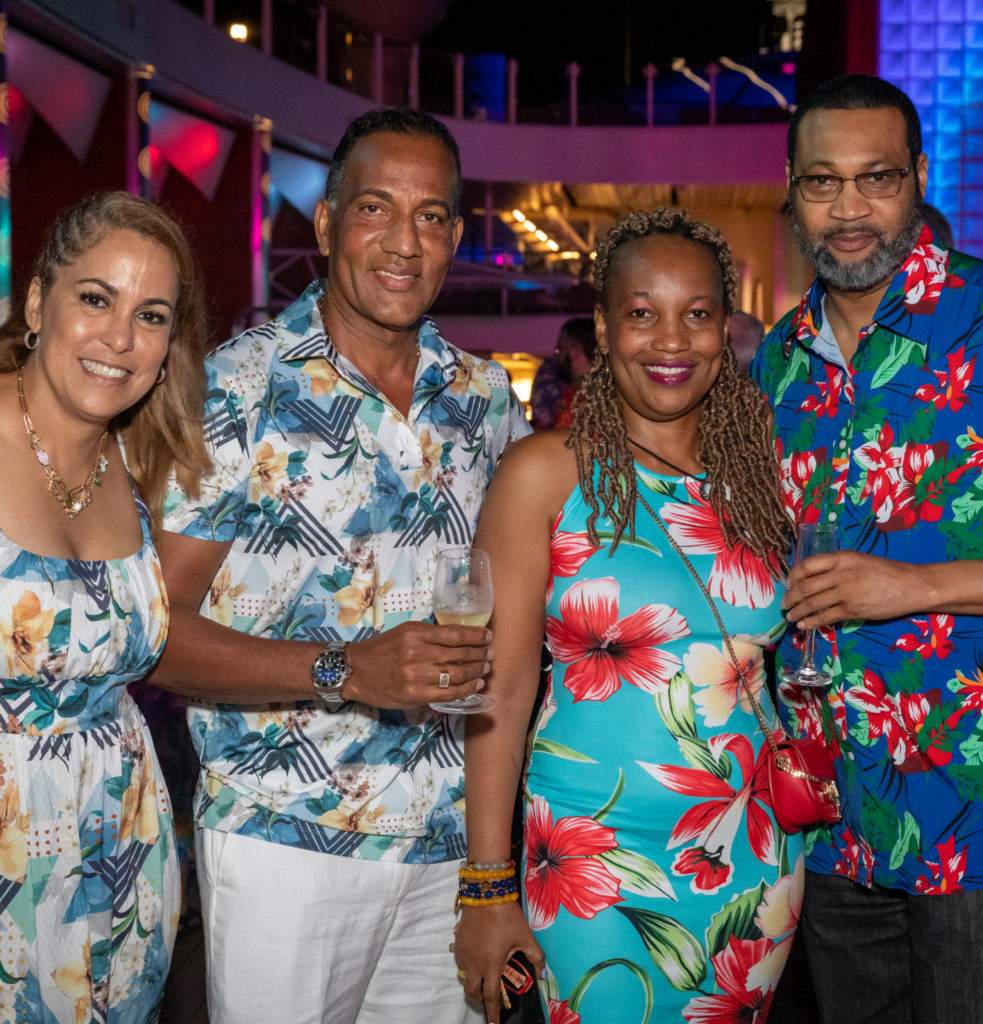Four adults wearing colorful vacation attire