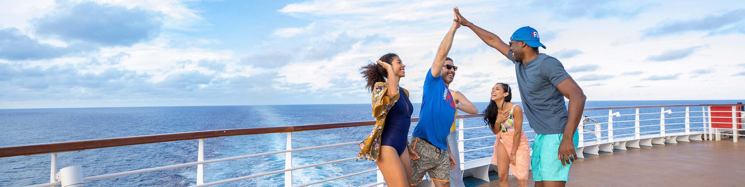 Friends high-fiving each other on a cruise ship