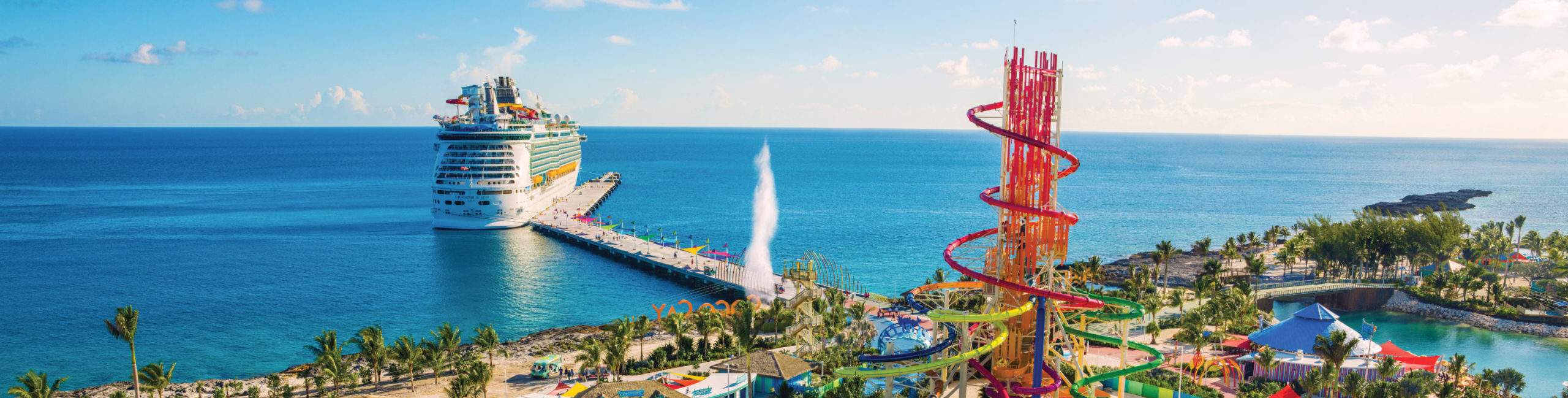 A cruise ship docked near a water park