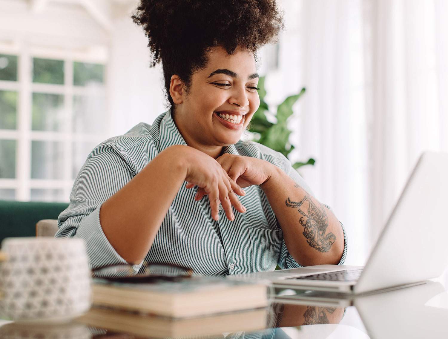 woman at desk smiling with laptop open searching part-time remote gigs