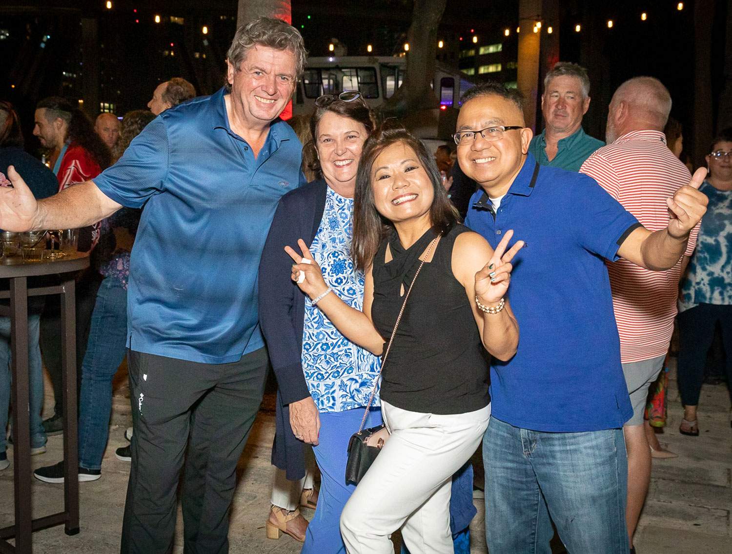 two men and two women posing for a picture - Can you be a travel agent part time