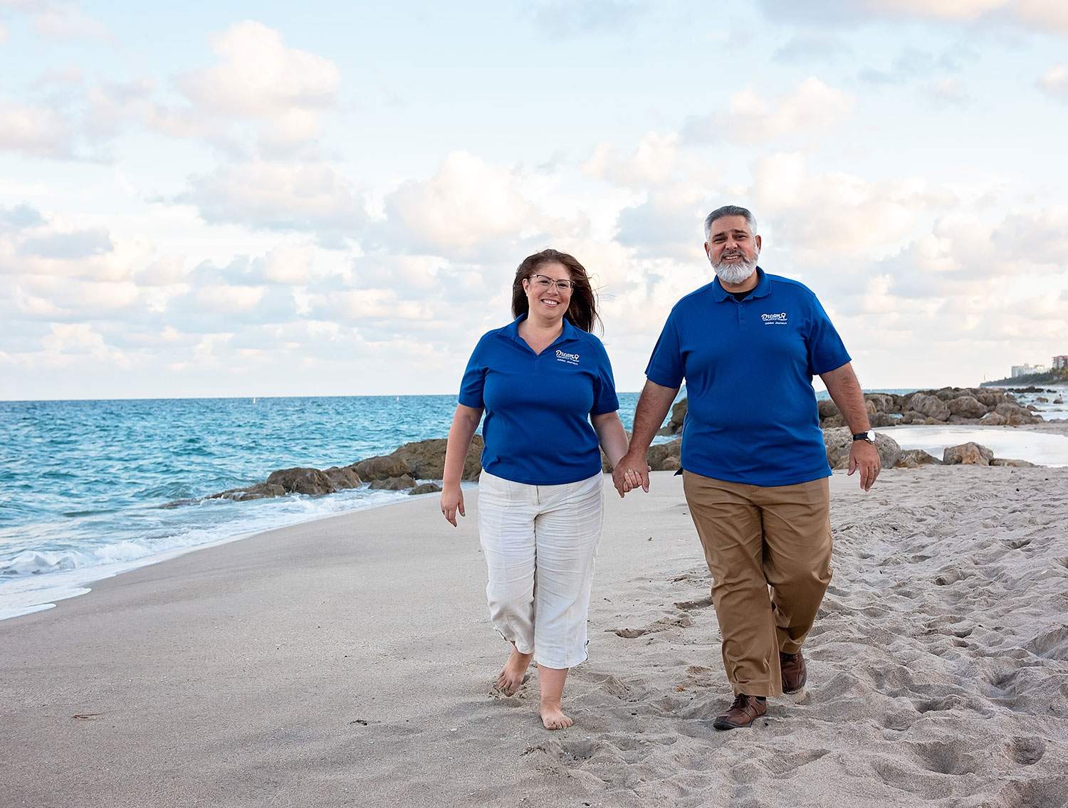 man and woman walking on the beach holding hands - how to make money as a digital nomad