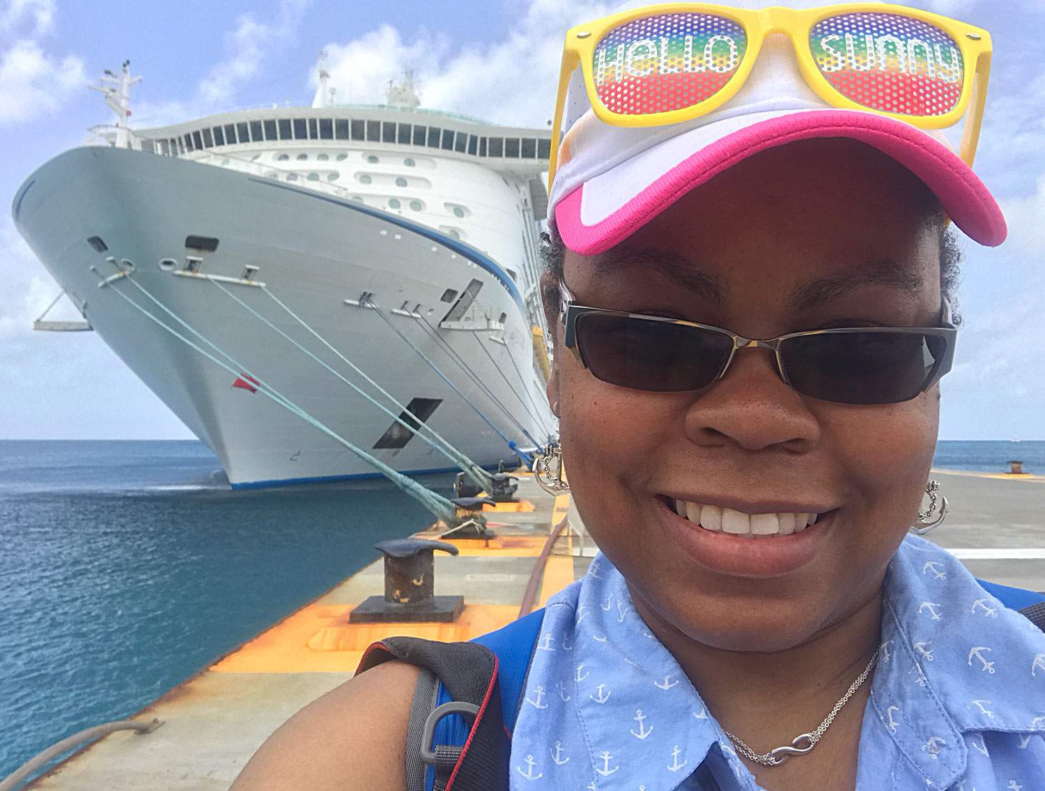 woman taking a selfie infront of a cruise ship - how to become a travel agent for cruise lines