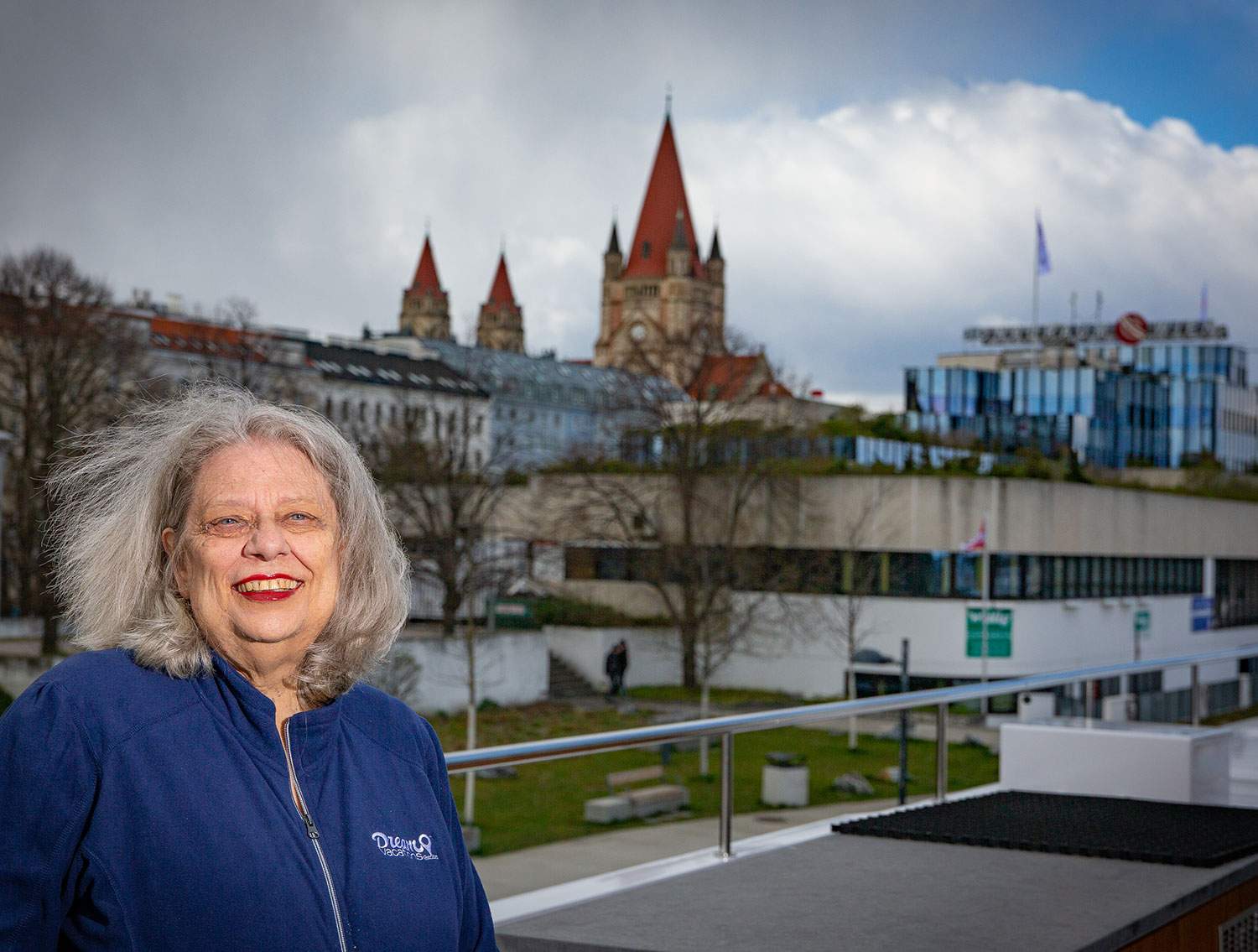 female Dream Vacations Advisor posing in front of touristy buildings