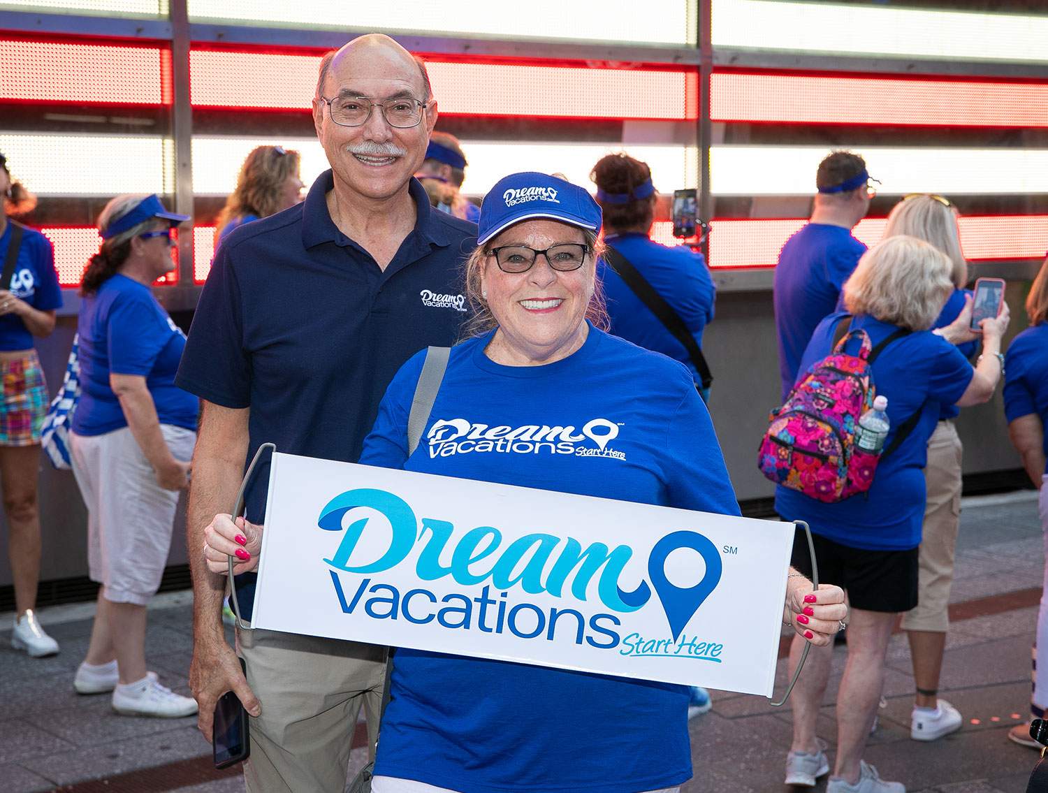 Dream Vacations Planner holding a sign
