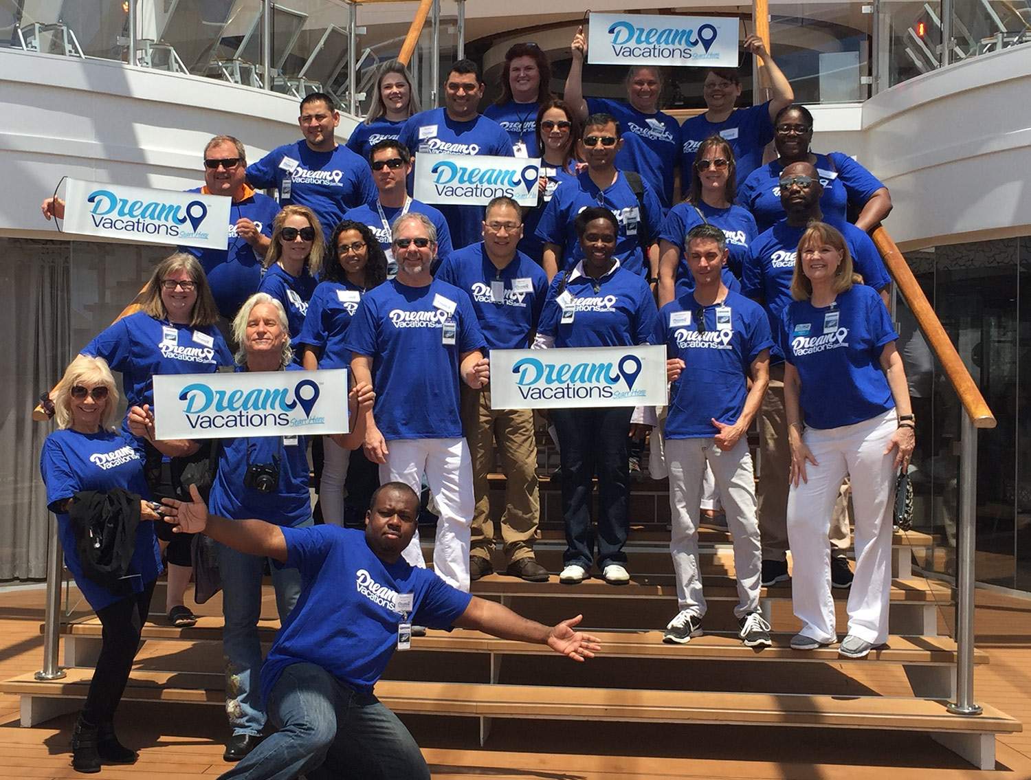 group of travel agents staggered on stairs for a photo