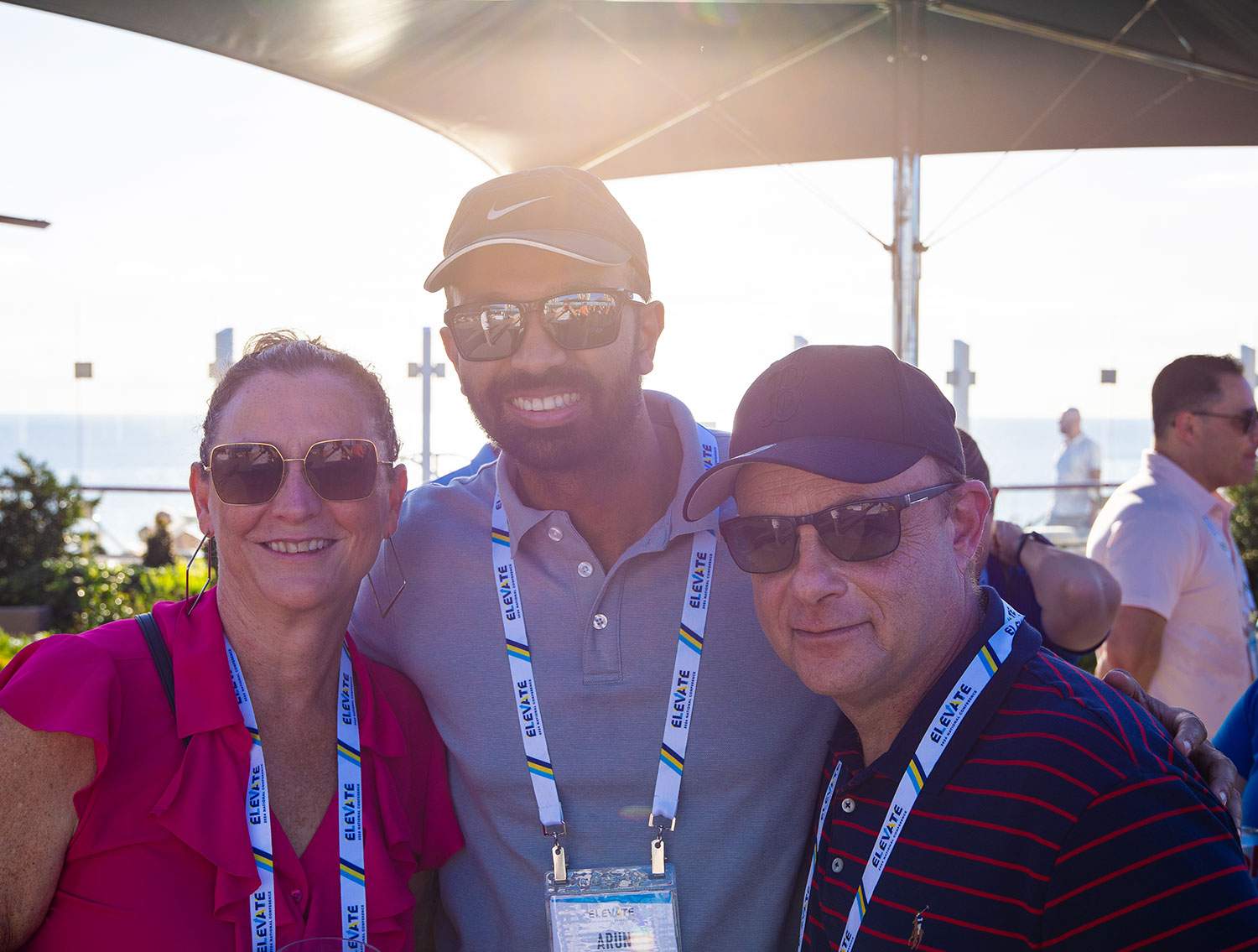 woman and two men posing for a picture
