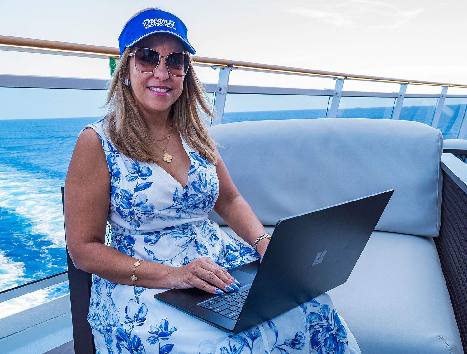 woman on a boat with her laptop on her lap
